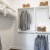 closet with organizers and clothes hanging