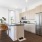 a kitchen with a stainless steel refrigerator