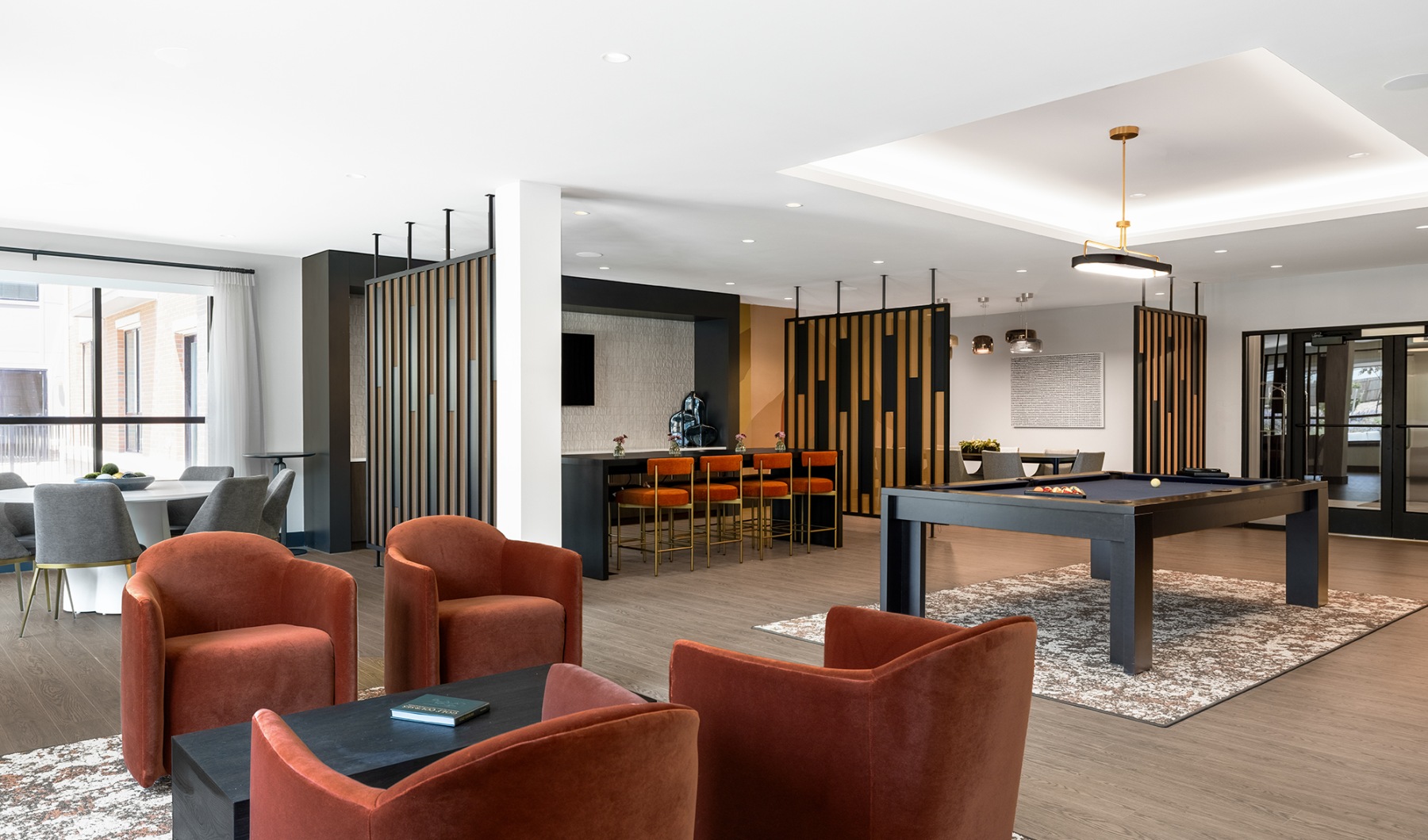 Take advantage of all Fairways at Cranford has to offer clubhouse with orange chairs and pool table