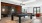 a room with a pool table and chairs