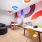 play room with tables and chairs and colorful mural