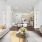  A beautifully designed living space with a soft neutral color palette, featuring a cozy sofa, modern dining table, and a fully equipped kitchen with wood cabinetry.