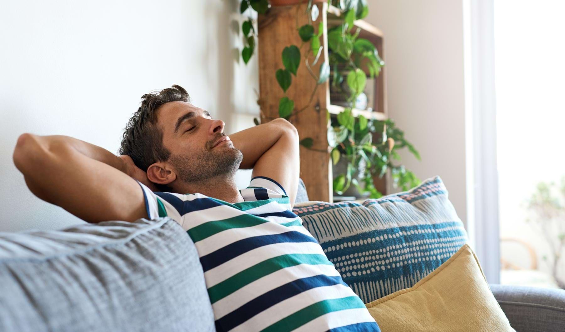 The essence of exceptional living a man sleeping on a couch