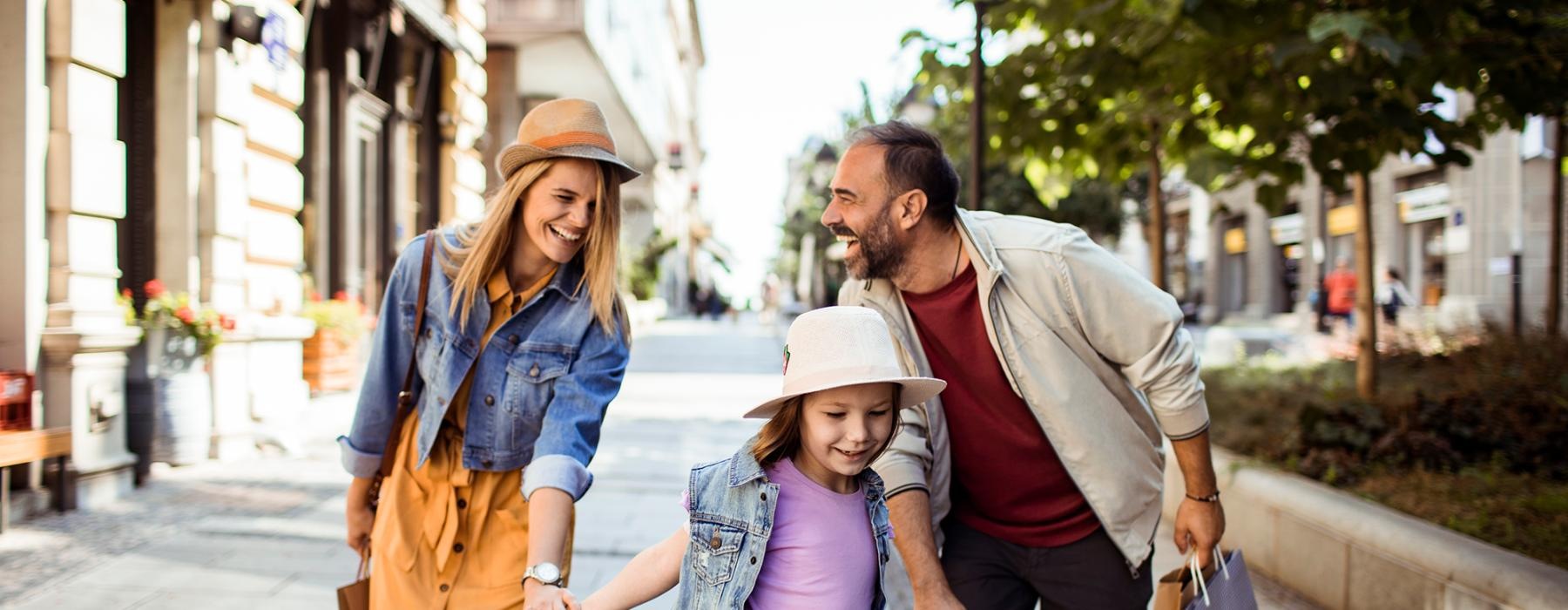 a family walking down a sidewalk